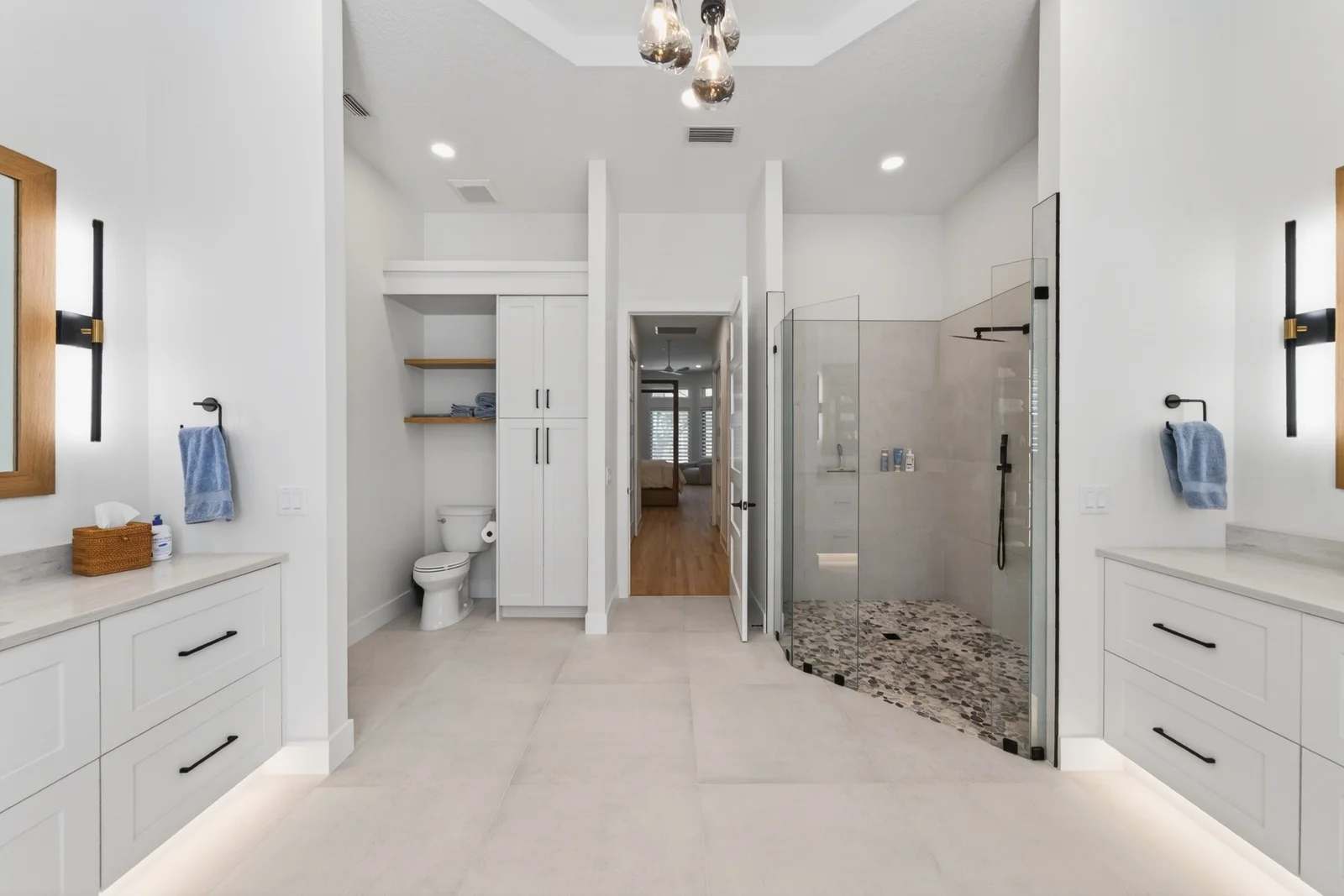 Gallery 15 Master bathroom with walk-in shower dual vanities and pebble floor in Venice
