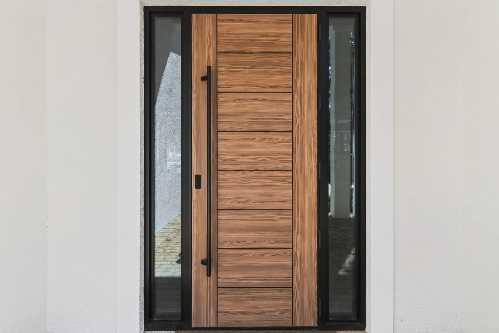 Gallery 7 Walnut horizontal-plank front door with black sidelights in Venice FL